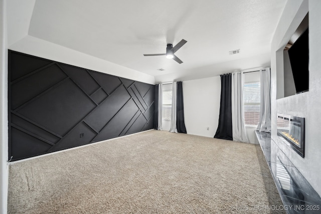 unfurnished bedroom with ceiling fan, carpet floors, and multiple windows