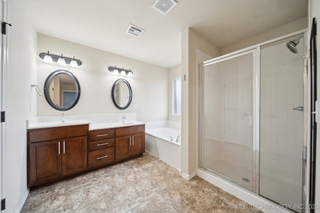 bathroom with vanity and independent shower and bath