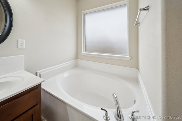 bathroom with vanity and a bath