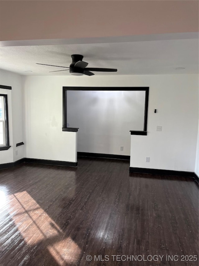 unfurnished room with ceiling fan, a textured ceiling, and dark hardwood / wood-style flooring