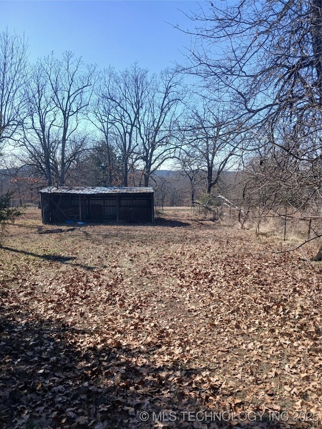 view of yard with an outbuilding and a rural view