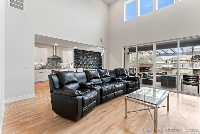 living room featuring sink and light hardwood / wood-style flooring