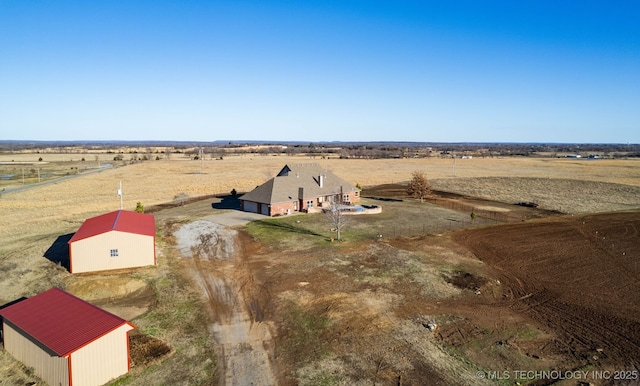 birds eye view of property with a rural view