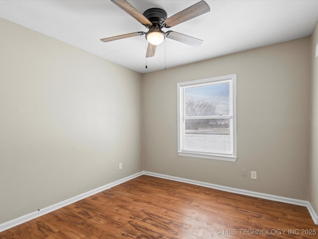 spare room with wood finished floors, baseboards, and ceiling fan