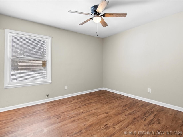 empty room with wood finished floors, baseboards, and ceiling fan