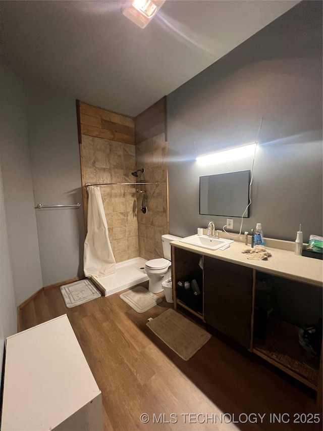 bathroom featuring vanity, curtained shower, toilet, and hardwood / wood-style flooring