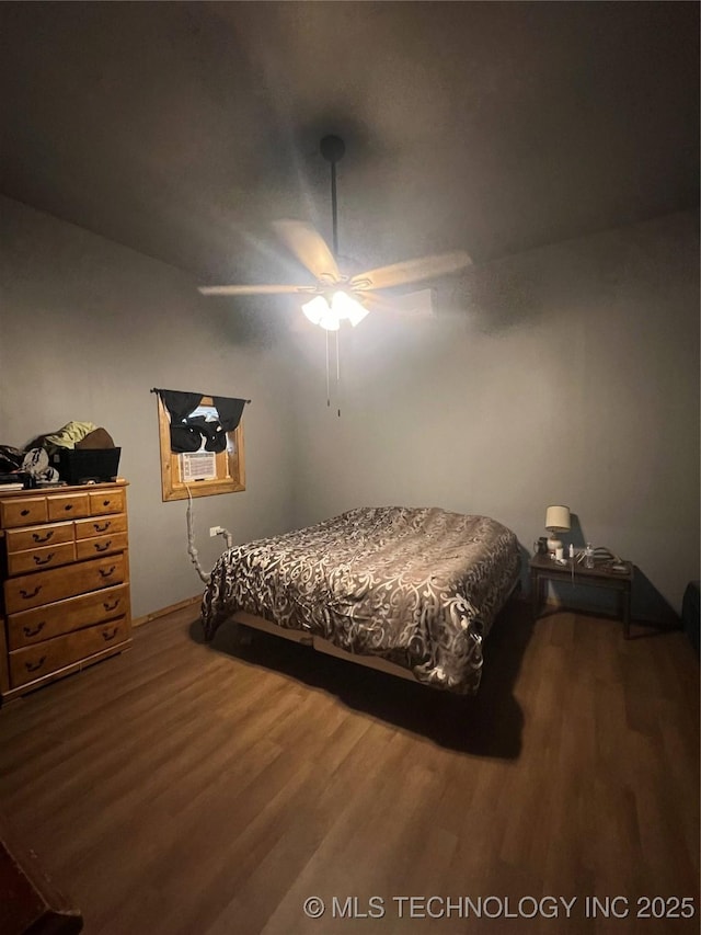 bedroom with hardwood / wood-style floors and ceiling fan