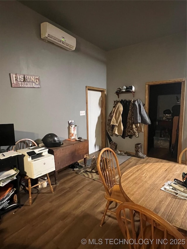 bedroom featuring a wall mounted air conditioner and hardwood / wood-style floors