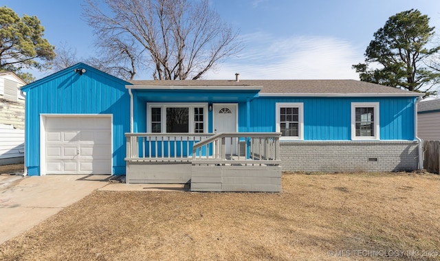 ranch-style house featuring a garage, a front lawn, and covered porch