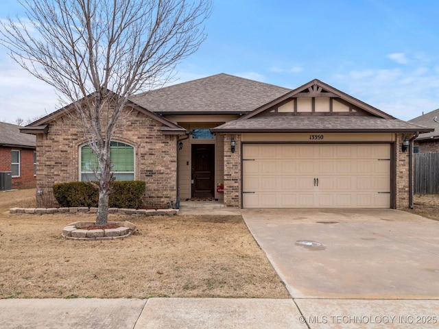 single story home featuring a garage and central air condition unit