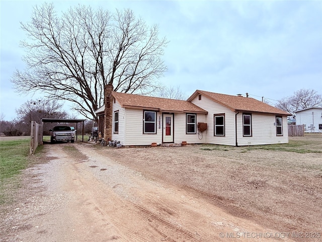 2420 3rd NE, Ardmore, OK 73401 - view of front of house featuring driveway, a chimney, and a carport