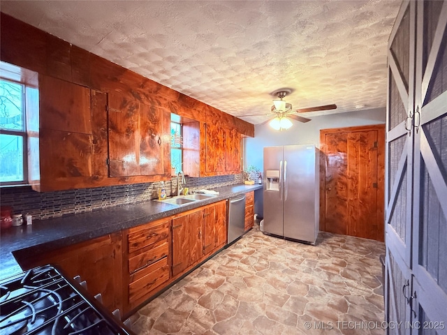 2420 3rd NE, Ardmore, OK 73401 - kitchen featuring stainless steel appliances, a sink, decorative backsplash, and plenty of natural light