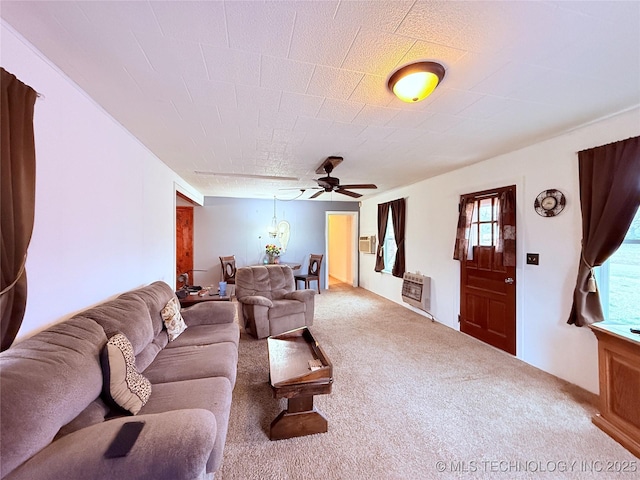 2420 3rd NE, Ardmore, OK 73401 - living area featuring carpet floors, ceiling fan, and heating unit