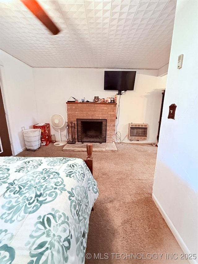 2420 3rd NE, Ardmore, OK 73401 - carpeted bedroom featuring an AC wall unit, a fireplace, and baseboards