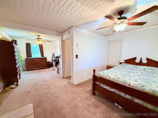 2420 3rd NE, Ardmore, OK 73401 - bedroom featuring light carpet, ceiling fan, and baseboards