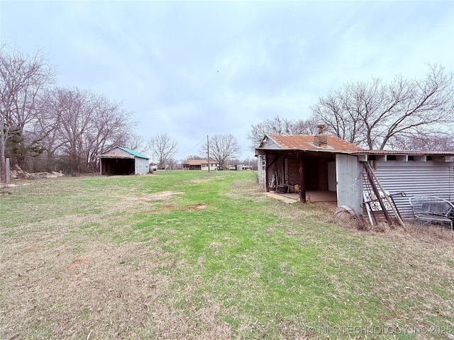 2420 3rd NE, Ardmore, OK 73401 - view of grassy yard with a pole building and an outdoor structure