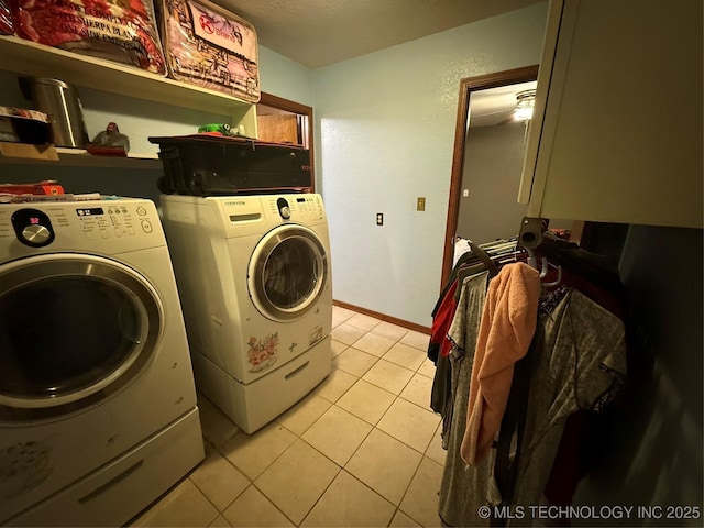 laundry room with washer and dryer and light tile patterned floors