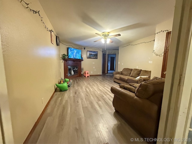 living room with ceiling fan and wood-type flooring