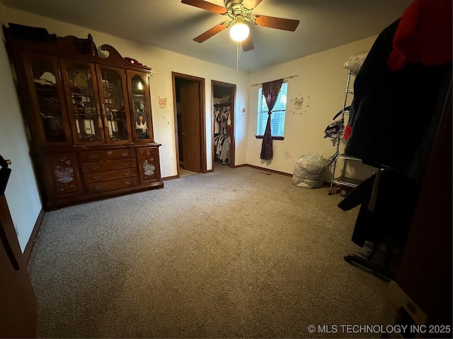 interior space featuring ceiling fan and carpet flooring