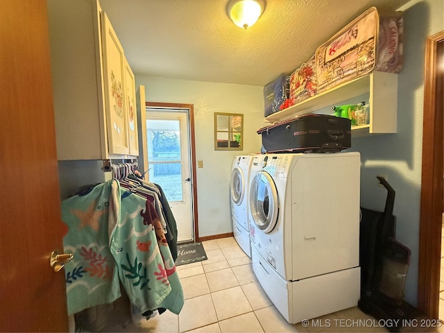 clothes washing area featuring separate washer and dryer, a textured ceiling, and light tile patterned floors