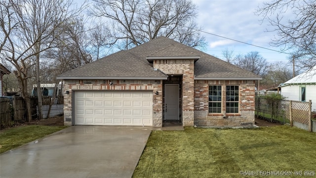 view of front of home featuring a garage and a front yard