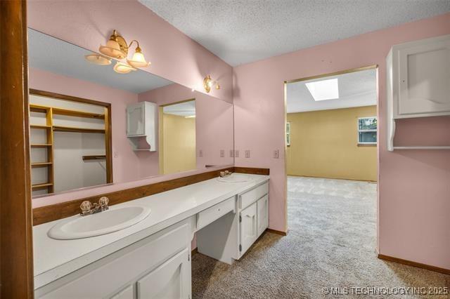 bathroom with vanity and a textured ceiling