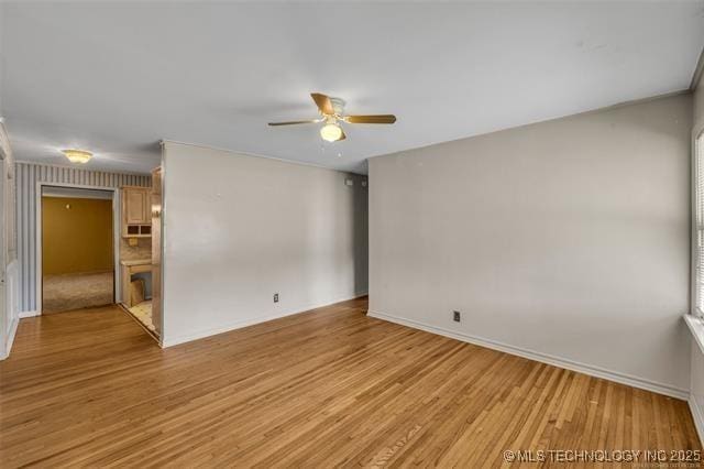 empty room featuring ceiling fan and light wood-type flooring