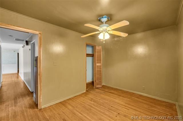 spare room featuring ceiling fan, ornamental molding, and light hardwood / wood-style floors