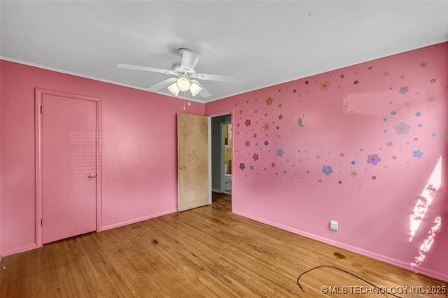 unfurnished bedroom featuring hardwood / wood-style flooring and ceiling fan