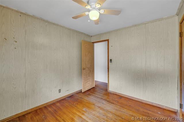 spare room with ceiling fan and light hardwood / wood-style floors