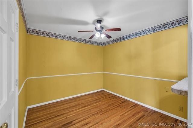 spare room featuring wood-type flooring and ceiling fan