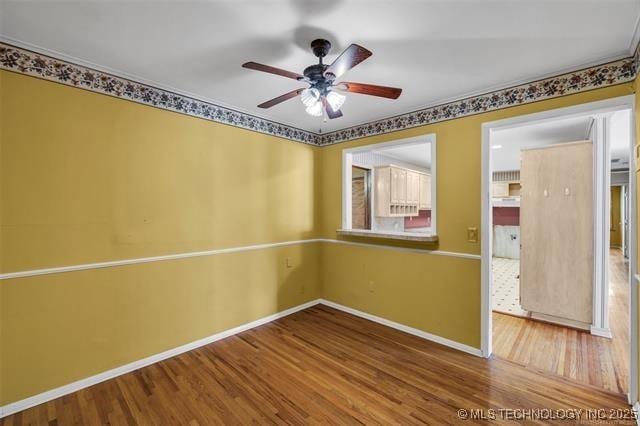 spare room with hardwood / wood-style floors and ceiling fan