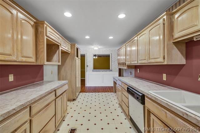 kitchen featuring dishwasher, sink, and light brown cabinets