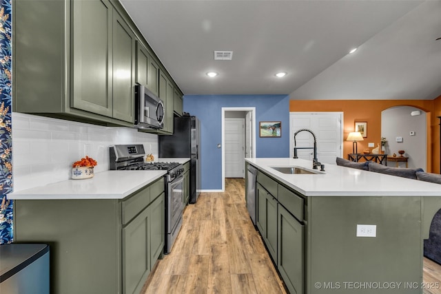 kitchen featuring appliances with stainless steel finishes, sink, and green cabinetry