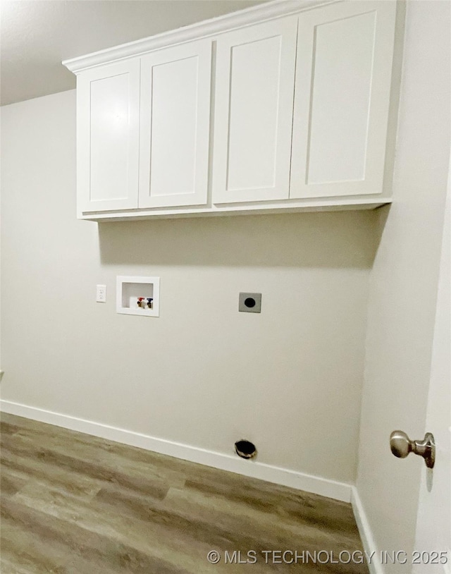 laundry area with washer hookup, wood-type flooring, and cabinets