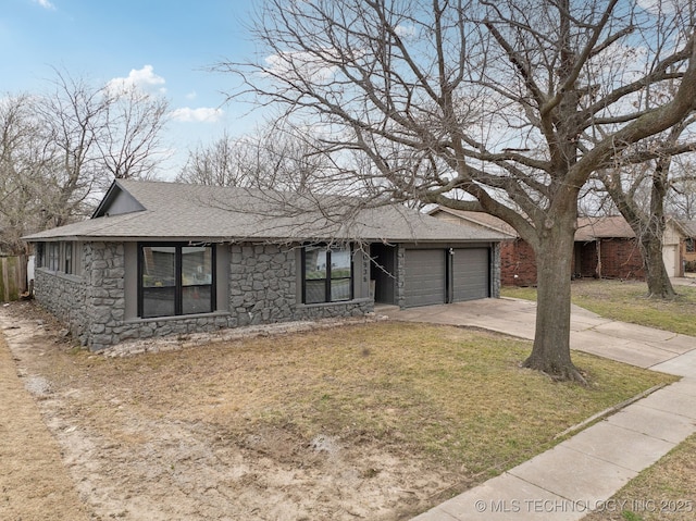 single story home featuring an attached garage, a shingled roof, concrete driveway, a front lawn, and stone siding