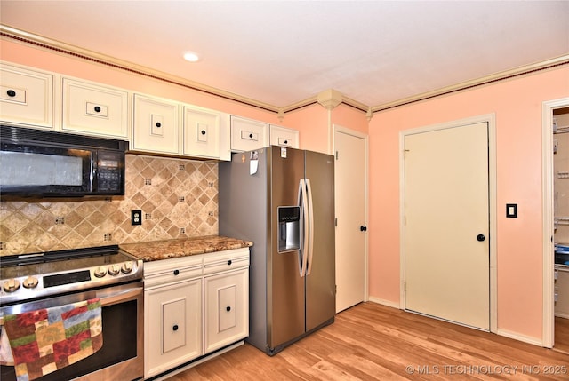 kitchen featuring backsplash, appliances with stainless steel finishes, light hardwood / wood-style flooring, and dark stone counters