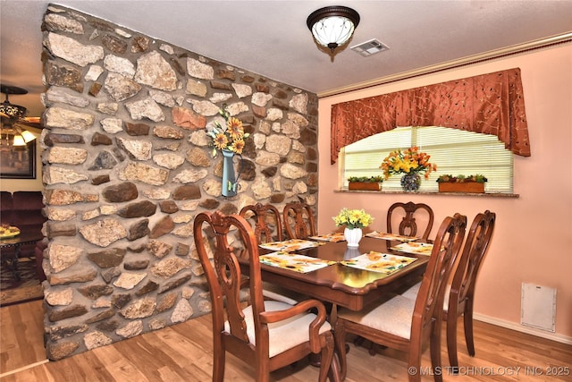 dining room featuring hardwood / wood-style floors and crown molding