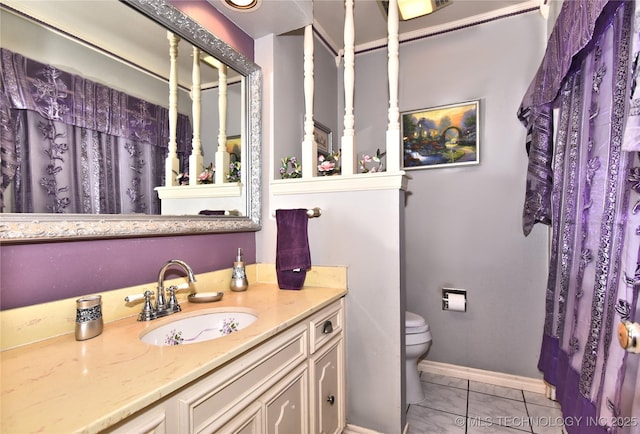 bathroom with vanity, walk in shower, tile patterned floors, and toilet