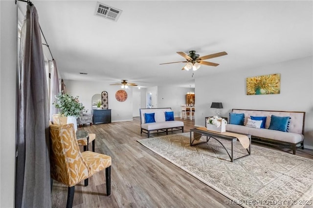 living room featuring hardwood / wood-style flooring and ceiling fan