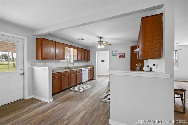 kitchen with beamed ceiling, sink, ceiling fan, white dishwasher, and light wood-type flooring