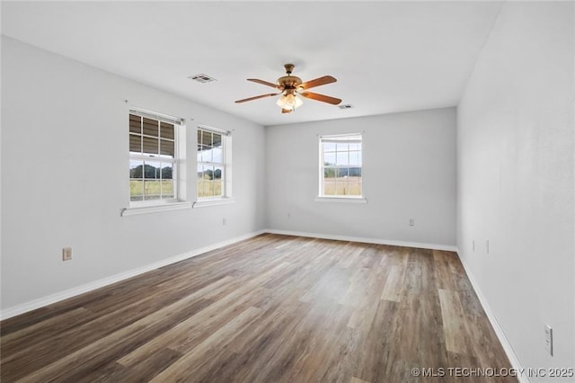 spare room featuring hardwood / wood-style flooring and ceiling fan