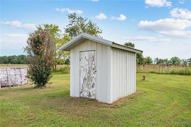 view of outbuilding featuring a yard