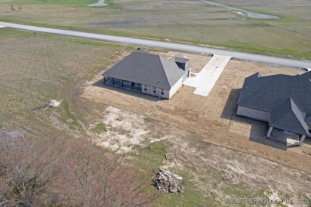 birds eye view of property with a rural view