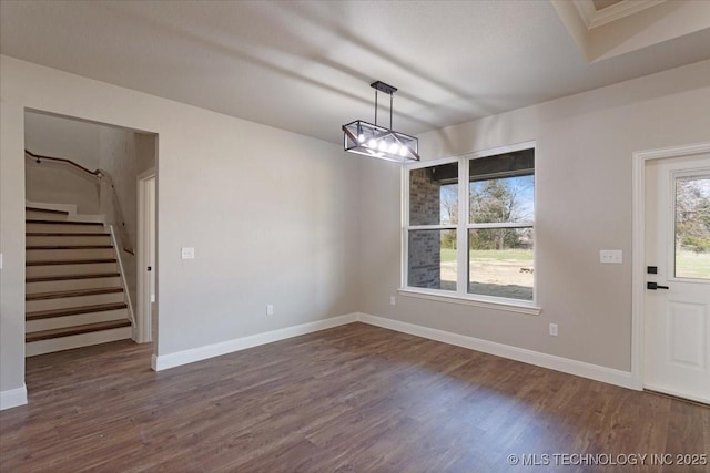 unfurnished dining area featuring an inviting chandelier and dark hardwood / wood-style flooring