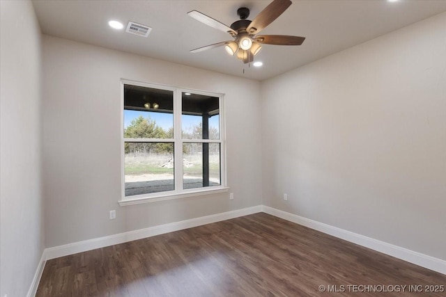 spare room featuring ceiling fan and dark hardwood / wood-style floors