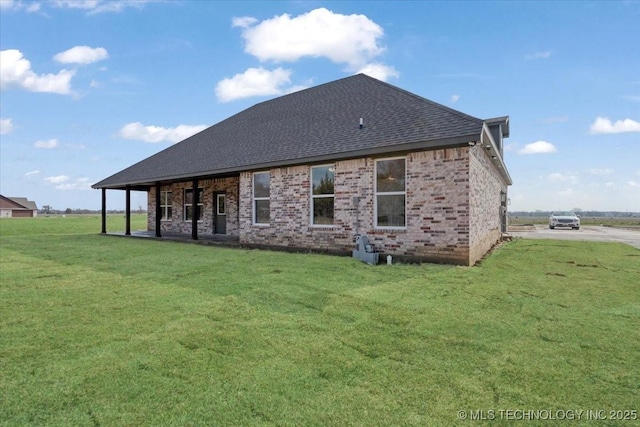 rear view of property featuring a yard