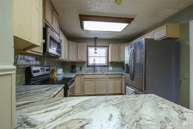 kitchen with sink, a textured ceiling, light brown cabinets, appliances with stainless steel finishes, and backsplash