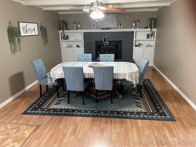 dining room with hardwood / wood-style flooring, ceiling fan, and beamed ceiling