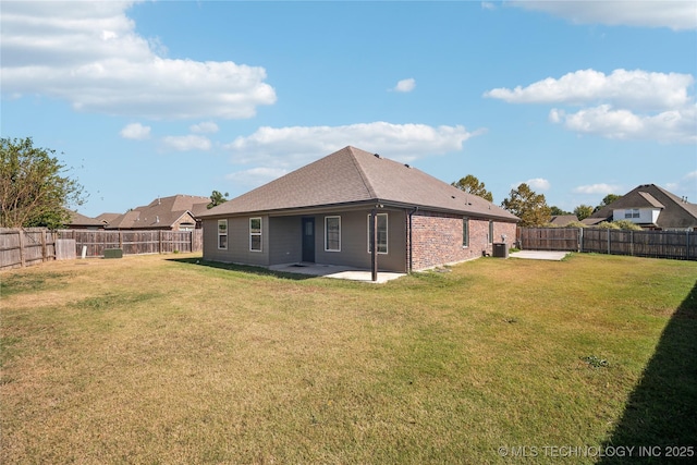 back of property with cooling unit, a patio area, and a lawn